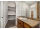 Bathroom with granite countertop, wood cabinets, and a walk-in closet at 3731 E Halifax Cir, Mesa, AZ 85205
