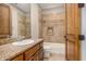 Bathroom with granite countertop, wood cabinets, shower, and bathtub at 3731 E Halifax Cir, Mesa, AZ 85205