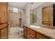 Bathroom with granite countertop, wood cabinets, and bathtub with shower at 3731 E Halifax Cir, Mesa, AZ 85205