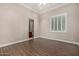 Spacious bedroom with wood-look flooring and a view into a bathroom at 3731 E Halifax Cir, Mesa, AZ 85205
