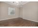 Bright bedroom with dark hardwood floors and window shutters at 3731 E Halifax Cir, Mesa, AZ 85205