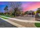 Luxury property with gated entry, lush lawn, and a captivating sunset view at 3731 E Halifax Cir, Mesa, AZ 85205