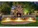 Stone fireplace with built-in seating in the backyard at 3731 E Halifax Cir, Mesa, AZ 85205