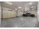 Spacious three-car garage with epoxy flooring at 3731 E Halifax Cir, Mesa, AZ 85205