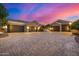 Three-car garage with modern doors and a spacious paved driveway at 3731 E Halifax Cir, Mesa, AZ 85205