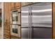 Stainless steel appliances and rich wood cabinets highlight this gourmet kitchen at 3731 E Halifax Cir, Mesa, AZ 85205