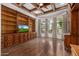 Spacious library with built-in wooden bookshelves and hardwood floors at 3731 E Halifax Cir, Mesa, AZ 85205