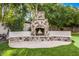 Stone outdoor fireplace with built-in seating area, perfect for entertaining at 3731 E Halifax Cir, Mesa, AZ 85205