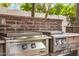 Stainless steel grill and griddle in an outdoor kitchen setting at 3731 E Halifax Cir, Mesa, AZ 85205