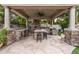 Fully equipped outdoor kitchen with pizza oven and stone countertops at 3731 E Halifax Cir, Mesa, AZ 85205