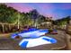 Inviting pool and spa with waterfall feature, surrounded by landscaping at 3731 E Halifax Cir, Mesa, AZ 85205