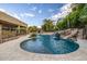 Inviting pool with a rock waterfall and integrated spa at 3731 E Halifax Cir, Mesa, AZ 85205