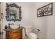 Elegant powder room with ornate mirror and stone sink at 3731 E Halifax Cir, Mesa, AZ 85205