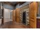 Walk-in wine cellar with wood shelving and wine fridge at 3731 E Halifax Cir, Mesa, AZ 85205