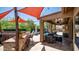 Outdoor kitchen and bar area flow into a covered patio and refreshing pool, creating an ideal entertainment space at 4119 S Las Villa Way, Gold Canyon, AZ 85118