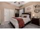 Bedroom featuring a queen sized bed, ceiling fan, and closet with sliding doors at 4119 S Las Villa Way, Gold Canyon, AZ 85118