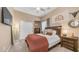 Bedroom featuring a ceiling fan, double bed, a slider closet door, and carpet at 4119 S Las Villa Way, Gold Canyon, AZ 85118