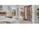 Bedroom featuring neutral carpet, windows with shutters, and a glass door to the outdoor patio at 4119 S Las Villa Way, Gold Canyon, AZ 85118