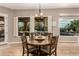 Inviting dining room with warm natural light, stylish seating, and view of an outdoor swimming pool at 4119 S Las Villa Way, Gold Canyon, AZ 85118