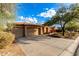 Two-car garage, desert landscaping, and a tan house with stone accents at 4119 S Las Villa Way, Gold Canyon, AZ 85118