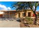 Tan house with stone accents, two-car garage, and desert landscaping at 4119 S Las Villa Way, Gold Canyon, AZ 85118