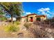 Tan house with stone accents and desert landscaping, two car garage at 4119 S Las Villa Way, Gold Canyon, AZ 85118