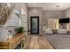 Inviting foyer with tile floors, accent wall, modern lighting, and striking front door with decorative glass inserts at 4119 S Las Villa Way, Gold Canyon, AZ 85118