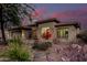 Charming single-story home featuring low-maintenance landscaping, a three-car garage, and a warm, inviting facade at 4119 S Las Villa Way, Gold Canyon, AZ 85118