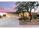 Charming home exterior featuring a three-car garage, stone accents, and a well-manicured desert landscape at 4119 S Las Villa Way, Gold Canyon, AZ 85118