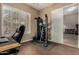 Home gym/office with wood tile flooring, window with blinds, and workout machine at 4119 S Las Villa Way, Gold Canyon, AZ 85118