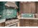 Modern kitchen features high-end appliances, vibrant backsplash, custom range hood, and designer finishes at 4119 S Las Villa Way, Gold Canyon, AZ 85118