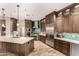 Modern kitchen with stainless steel appliances, custom cabinetry, and an island with a sink at 4119 S Las Villa Way, Gold Canyon, AZ 85118