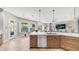Open kitchen design with large windows, wood cabinets and hardwood flooring at 4119 S Las Villa Way, Gold Canyon, AZ 85118
