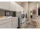 Bright laundry room features a sink, generous storage, and side-by-side washer and dryer for convenience at 4119 S Las Villa Way, Gold Canyon, AZ 85118