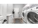Well-lit laundry room with updated washer, dryer, and organized storage at 4119 S Las Villa Way, Gold Canyon, AZ 85118