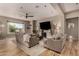 Well-lit living room featuring hardwood floors, comfortable seating, a modern ceiling fan, and a view of the outside at 4119 S Las Villa Way, Gold Canyon, AZ 85118