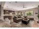 Open-concept living room featuring hardwood floors, modern ceiling fan, lots of comfortable seating, and natural light at 4119 S Las Villa Way, Gold Canyon, AZ 85118