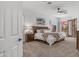 Main bedroom featuring neutral carpet, a ceiling fan, white walls, and a door leading to the outside at 4119 S Las Villa Way, Gold Canyon, AZ 85118