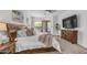 Comfortable main bedroom featuring a king-size bed, dresser, and access to a private patio at 4119 S Las Villa Way, Gold Canyon, AZ 85118