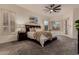 Relaxing bedroom featuring a king-sized bed, plush bedding, ceiling fan, and a private outdoor access at 4119 S Las Villa Way, Gold Canyon, AZ 85118