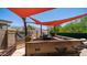 Well-equipped outdoor kitchen with a built-in grill, counter space, and seating, ideal for outdoor entertaining at 4119 S Las Villa Way, Gold Canyon, AZ 85118