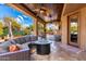 Covered patio with seating area, fire pit, and pool view at 4119 S Las Villa Way, Gold Canyon, AZ 85118
