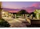 Resort-style pool with lounge chairs and lush landscaping, perfect for relaxation and entertainment with a sunset sky at 4119 S Las Villa Way, Gold Canyon, AZ 85118