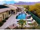 Inviting backyard oasis with a sparkling pool, outdoor kitchen, and scenic mountain views at 4119 S Las Villa Way, Gold Canyon, AZ 85118