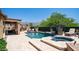 Expansive backyard showcases a pool, spa, and covered patio, ideal for outdoor entertaining and relaxation at 4119 S Las Villa Way, Gold Canyon, AZ 85118