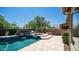 Beautiful pool with a cascading water feature, lush landscaping, and a tranquil backyard retreat at 4119 S Las Villa Way, Gold Canyon, AZ 85118