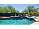 Beautiful pool with a cascading water feature and serene landscaping creates a tranquil backyard retreat at 4119 S Las Villa Way, Gold Canyon, AZ 85118