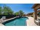 Inviting backyard pool features a basketball hoop, surrounded by lush greenery and comfortable patio furniture at 4119 S Las Villa Way, Gold Canyon, AZ 85118