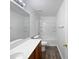 Clean bathroom with shower/tub combo and wood cabinets at 41876 W Corvalis Ln, Maricopa, AZ 85138
