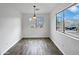Bright dining area with wood flooring and a window at 41876 W Corvalis Ln, Maricopa, AZ 85138